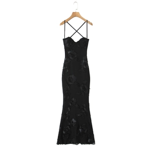 Close-up of black bodycon evening dress with 3D floral lace and chiffon mermaid hem