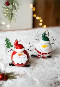 Christmas tree ornaments featuring Santa Claus and snowman iron pendants on soft white snow