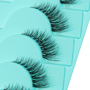 Macro detail of 5D faux mink half-lashes with transparent band on a blue tray