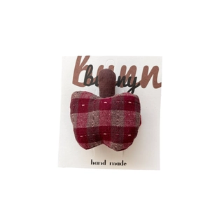 Handmade red and brown plaid fabric apple hair clip on a white display card
