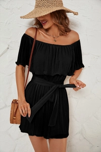 Detail of elegant black off-shoulder pleated jumpsuit with matching waist tie design