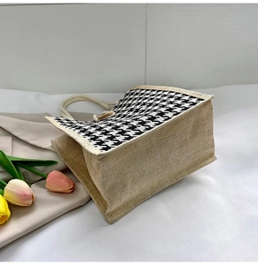 Close-up of canvas tote bag featuring textured burlap and houndstooth pattern fabric