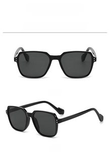 Detail view showing front and side angles of black thick frame oversized sunglasses C.01