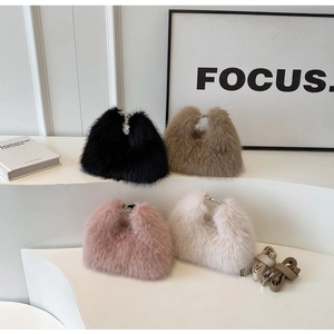 Detail of four fluffy faux fur handbags in assorted colors with metal clasps and leather straps