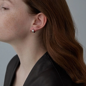Macro shot of S925 silver stud earrings featuring a triple parallel line texture design