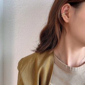 Close-up of triple-layered gold ear cuff with sparkling zircon inlay for non-pierced ears