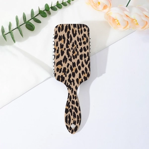 Detail of leopard print air cushion hair brush with massage bristles and hanging hole