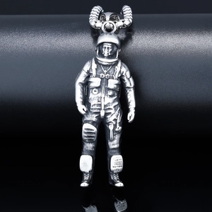 Detailed macro view of retro silver astronaut pendant showing fine mechanical textures