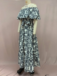 Detail of ruffled off-shoulder neckline and waist tie on damask print maxi dress