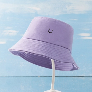Lavender canvas bucket hat with embroidered smiley face for sun protection and style