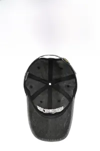 Detail view of washed cotton baseball cap interior with stitching and metal buckle