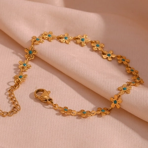 Detail of 18K gold-plated chain bracelet with blue flower charms and lobster clasp closure