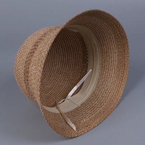 Detailed view of the internal adjustable beige ribbon and woven texture on a brown sun hat