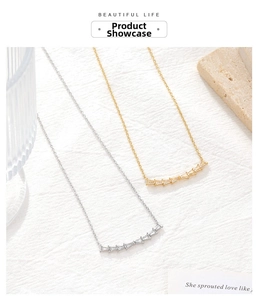 Detail of minimalist baguette-cut zircon smile necklaces in gold and silver finishes