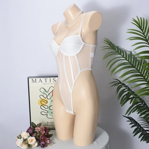Detail of white mesh bodysuit with corset boning and bow accent on mannequin