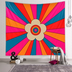 Bohemian rainbow floral tapestry hanging on a white brick wall in a cozy room setting