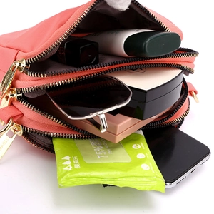 Portable coral orange nylon crossbody bag with three zipper compartments and large capacity
