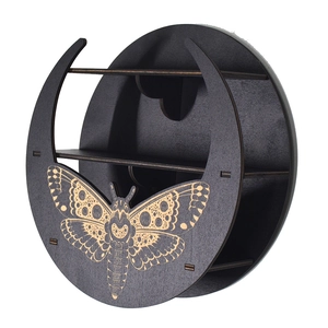 Detail of black round wooden shelf with golden butterfly motifs and two storage tiers