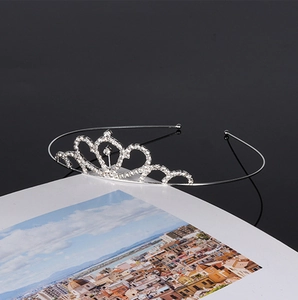 Detailed view of bridal crown headband with sparkling clear rhinestones on silver base