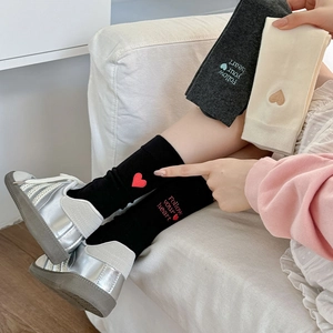 Detail of Follow your heart embroidery on knit cotton mid-calf socks in three colors