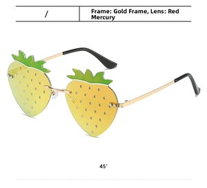 Detail view of strawberry shaped sunglasses with gold temples and red gradient lenses