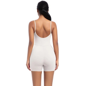 Detail of thin straps and deep backless design on a beige seamless yoga bodysuit