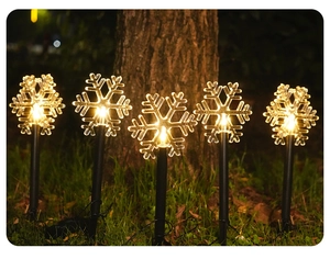 Outdoor solar lawn stakes with five glowing warm white snowflakes for garden decoration