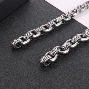 Macro detail of 12mm silver punk titanium steel chain necklace with ornate textures
