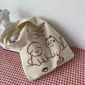 Detail of canvas tote bag with burgundy pet illustration on red checkered fabric