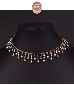 Detailed view of handmade pearl tassel necklace on a black velvet neck bust display