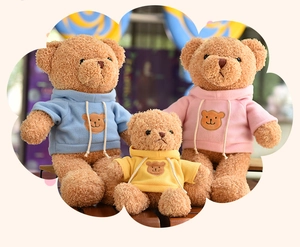 Three soft brown teddy bears wearing colorful hoodies in blue, pink, and yellow.