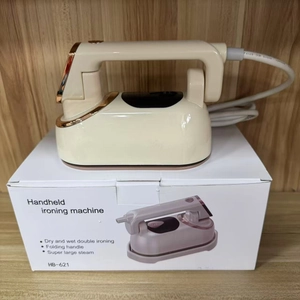 Detail view of foldable handheld steam iron HB-621 with retail box on wood background