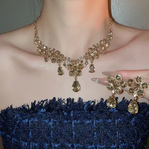 Elegant floral teardrop pendant necklace and earring set with champagne crystals