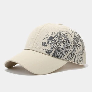Detail of dragon print on beige quick-dry mesh fabric of the breathable baseball cap