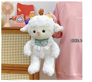 Close-up of fluffy white plush lamb bag featuring a heart-patterned lace bib for girls