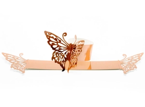 Detail of rose gold laser-cut butterfly napkin ring made of pearl paper cardstock