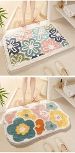 Detail of plush floral bath mats showing water-absorbent texture and colorful patterns