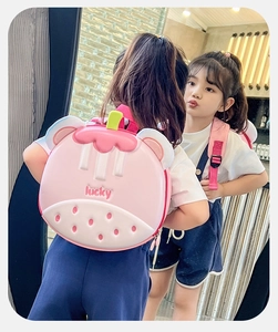 Detail view of pink strawberry eggshell backpack with lucky print and adjustable straps