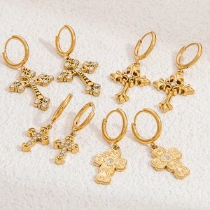 Detailed view of four pairs of gold stainless steel cross earrings with zircon accents