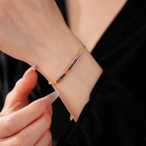 Macro view of adjustable gold chain bracelet with rainbow zircon crystals on wrist
