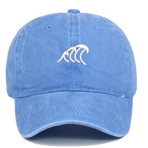 Detail of white wave embroidery on a vintage washed blue cotton baseball cap