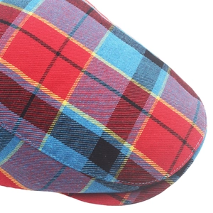 Macro shot of red and blue tartan check pattern on casual flat cap fabric and stitching