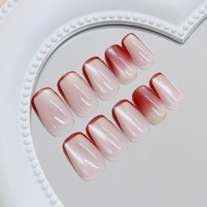 French cat eye press-on nails with red gradient and pearl tray display in retro style
