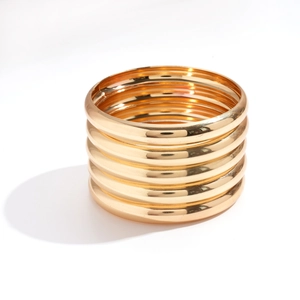 Five-piece set of minimalist polished gold geometric round bangles with metallic finish