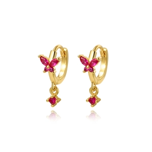 Detail of gold-plated butterfly earrings with pink zircon stones on a white background