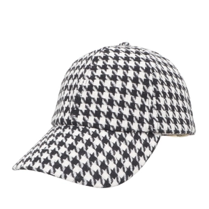 Classic black and white houndstooth baseball cap with a curved brim for women
