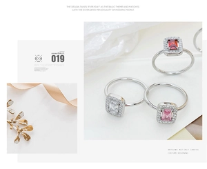 Close-up of three colorful rectangular zircon rings with halo setting in silver finish