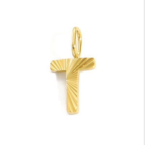 Macro shot of gold stainless steel letter T pendant with radial texture on white background