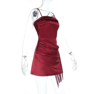 Detail of burgundy satin mini dress with elegant pleated draping and silk texture