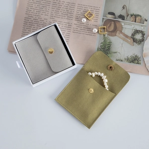 Premium velvet jewelry pouch in grey and olive green with snap button closure and gift box